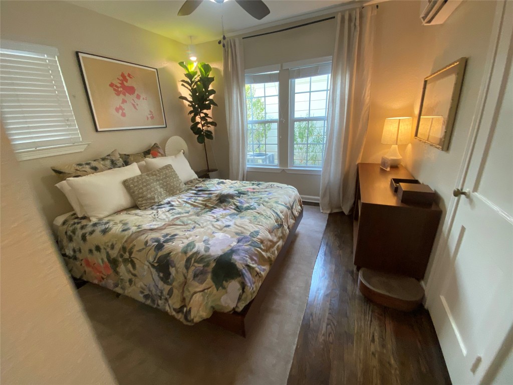 1404 West 12th Street, Unit C Austin, TX 78703 - Photo 20 of 34 a bed sitting in a bedroom next to a window