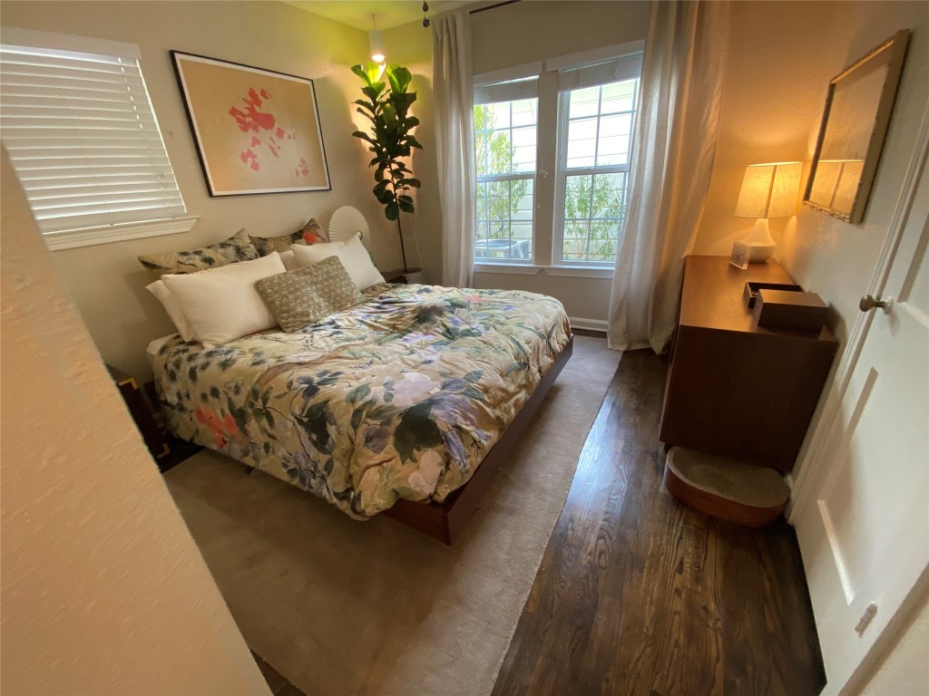 1404 West 12th Street, Unit C Austin, TX 78703 - Photo 21 of 34 a bed sitting in a bedroom next to a window