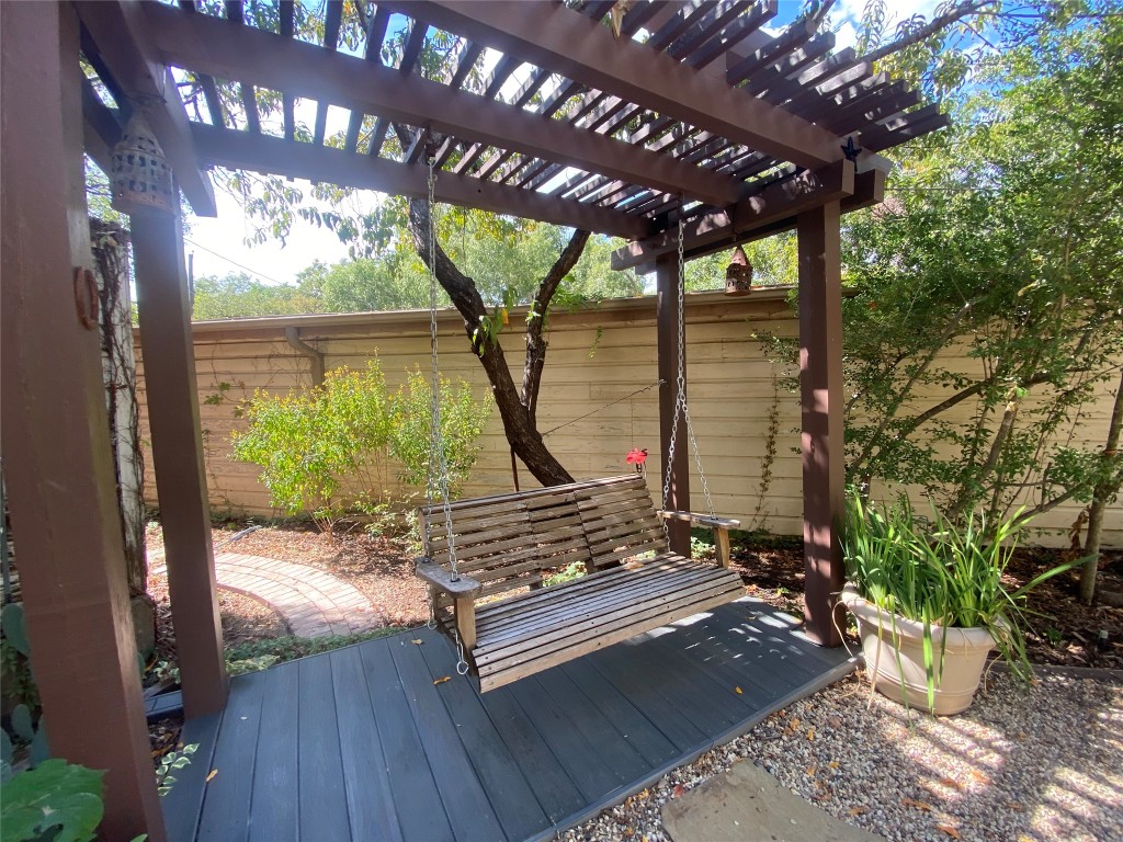 1404 West 12th Street, Unit C Austin, TX 78703 - Photo 24 of 34 a wooden bench sitting in front of a building