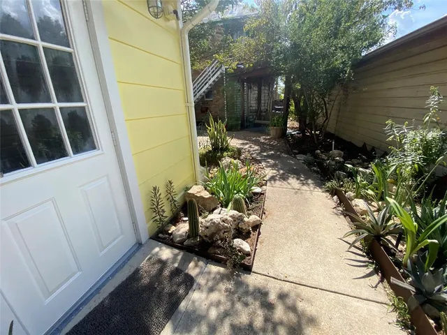 a backyard of a house with table and chairs