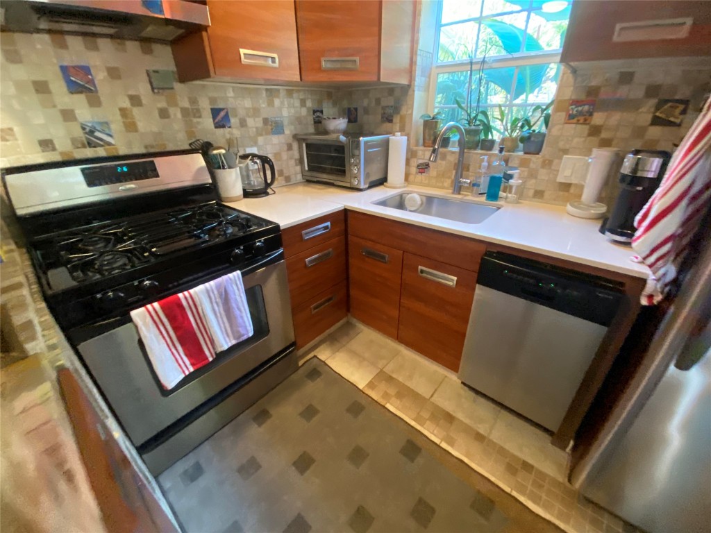 1404 West 12th Street, Unit C Austin, TX 78703 - Photo 10 of 34 a kitchen with a stove and a microwave