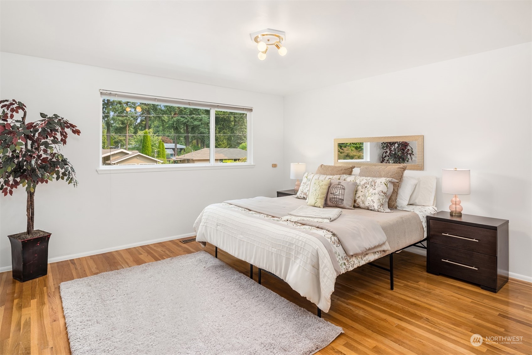 9523 Northeast 198th Street Bothell, WA 98011 - Photo 20 of 39 a bedroom with a bed and a potted plant