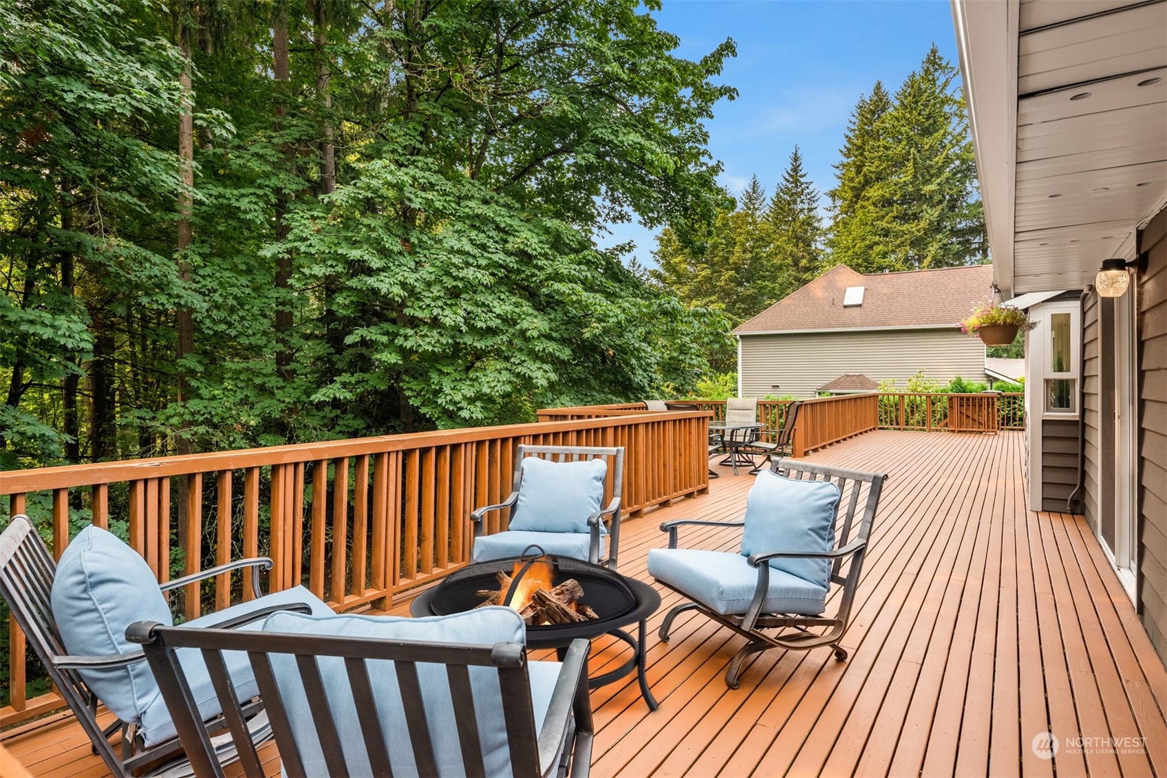 9523 Northeast 198th Street Bothell, WA 98011 - Photo 29 of 39 a view of a patio with a table and chairs with wooden floor and fence