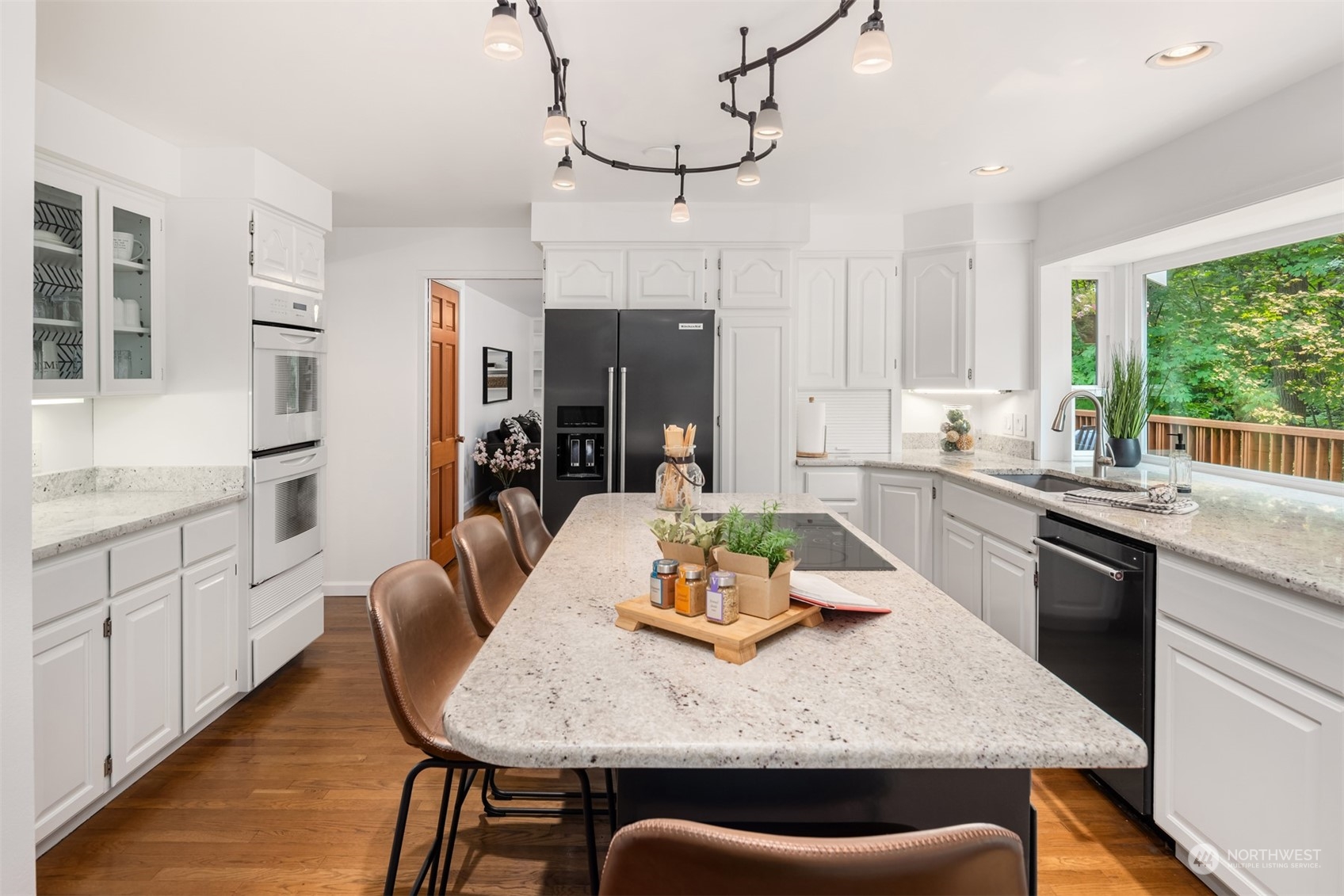 9523 Northeast 198th Street Bothell, WA 98011 - Photo 6 of 39 a kitchen with stainless steel appliances granite countertop a kitchen island a stove a table and chairs