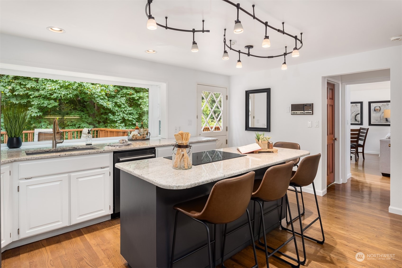 9523 Northeast 198th Street Bothell, WA 98011 - Photo 7 of 39 a dining hall with stainless steel appliances granite countertop a sink a counter space chairs and couches