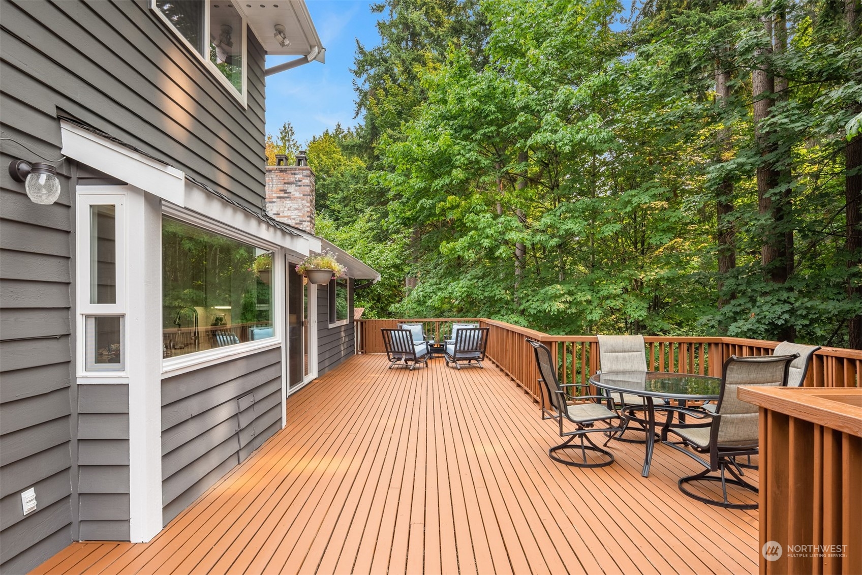 9523 Northeast 198th Street Bothell, WA 98011 - Photo 9 of 39 a balcony with wooden floor table and chairs