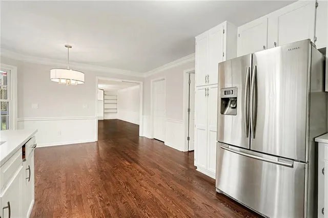 a view of a livingroom with wooden floor a fireplace and windows