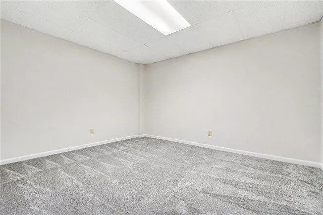 a view of room with air conditioner duct and white walls
