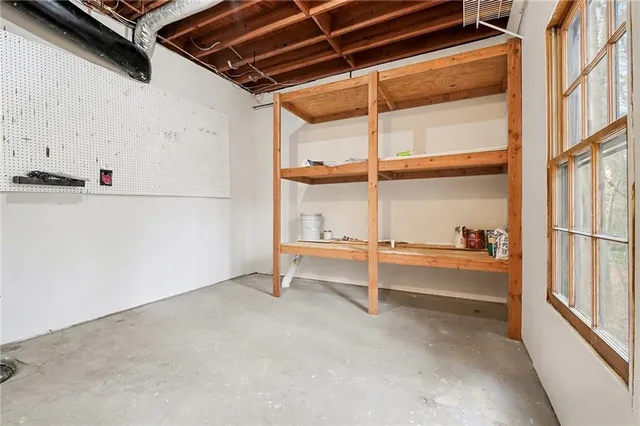 a view of a balcony with a floor to ceiling window and wooden fence