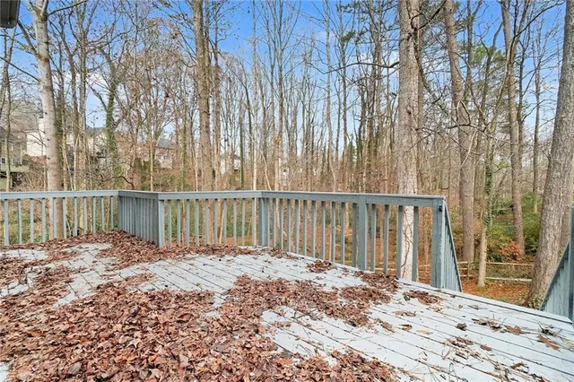 a view of a backyard with floor to ceiling windows and yard