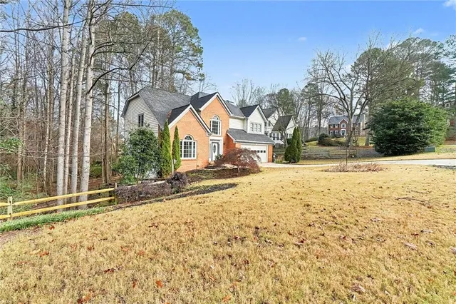 a view of a yard with snow on the road
