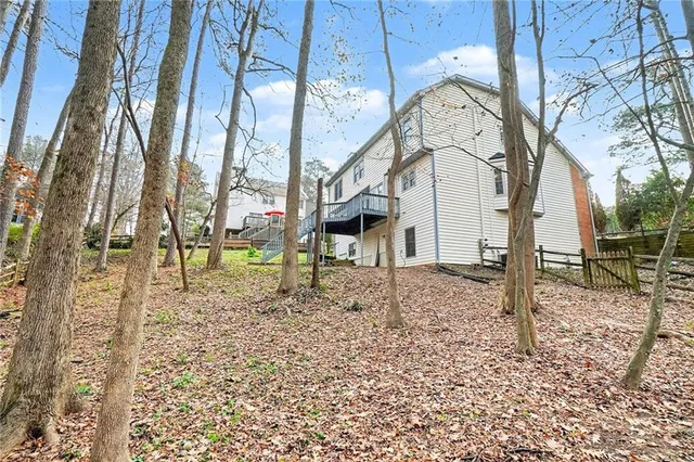 a view of a yard with plants and brick wall