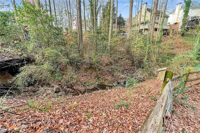 a front view of house along with deck and outdoor seating