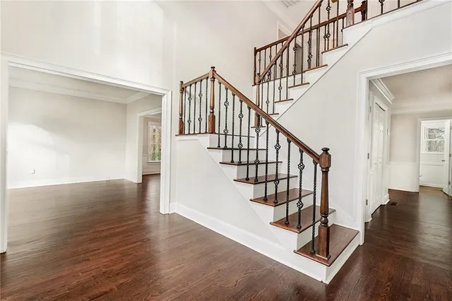 a view of entryway with wooden floor and stairs