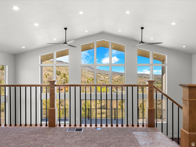 1159 North Broad Hollow Road Garden City, UT 84028 - Photo 5 of 55 Loft with large picture windows, recessed lighting, and wood-finish railing with black balusters