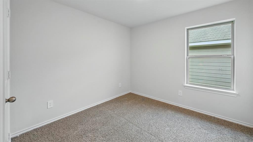 1908 Freeman Street Tyler, TX 75704 - Photo 26 of 30 Neutral color palette room featuring light gray walls, plush gray carpet, a single window, and a white baseboard trim