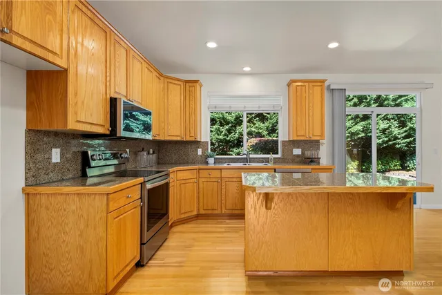 a kitchen with stainless steel appliances granite countertop a stove and a sink