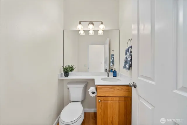 a bathroom with a toilet sink and mirror