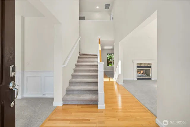 a view of a hallway with wooden floor and entryway