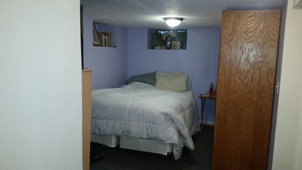 16 Hovey Road Waltham, MA 02453 - Photo 8 of 10 a bedroom with a bed and a wall painting