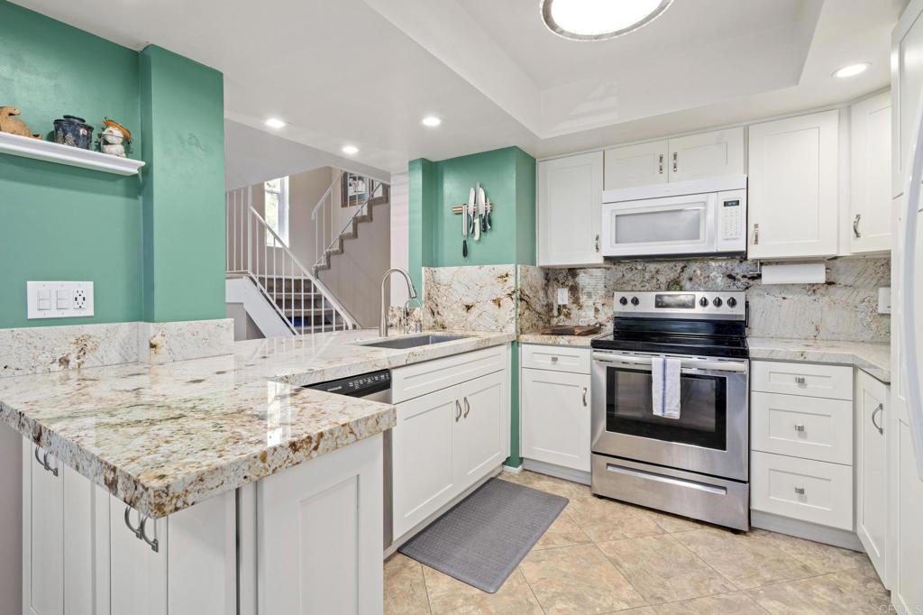 a kitchen with granite countertop a sink and cabinets