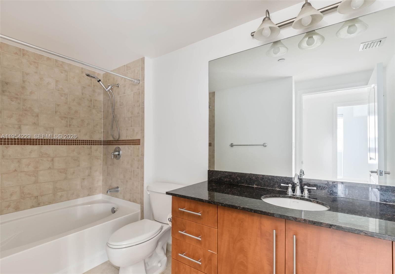 7355 Southwest 89th Street, Unit 502N Miami, FL 33156 - Photo 11 of 15 a bathroom with a granite countertop sink toilet and shower