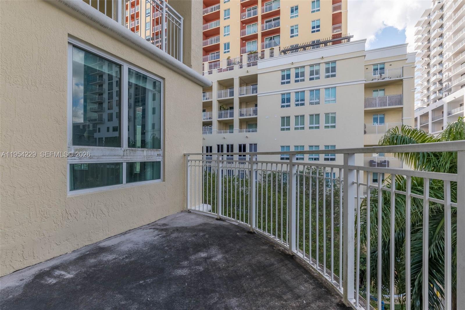 7355 Southwest 89th Street, Unit 502N Miami, FL 33156 - Photo 13 of 15 a view of a building from a porch