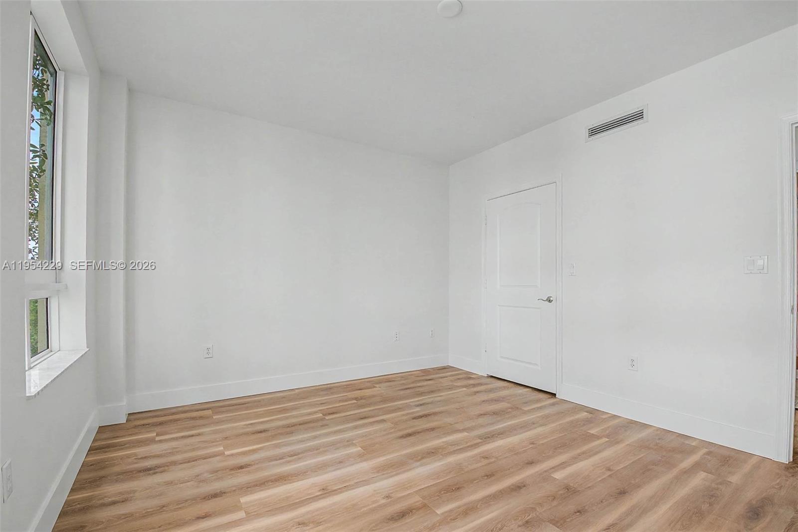 7355 Southwest 89th Street, Unit 502N Miami, FL 33156 - Photo 7 of 15 a view of empty room with wooden floor