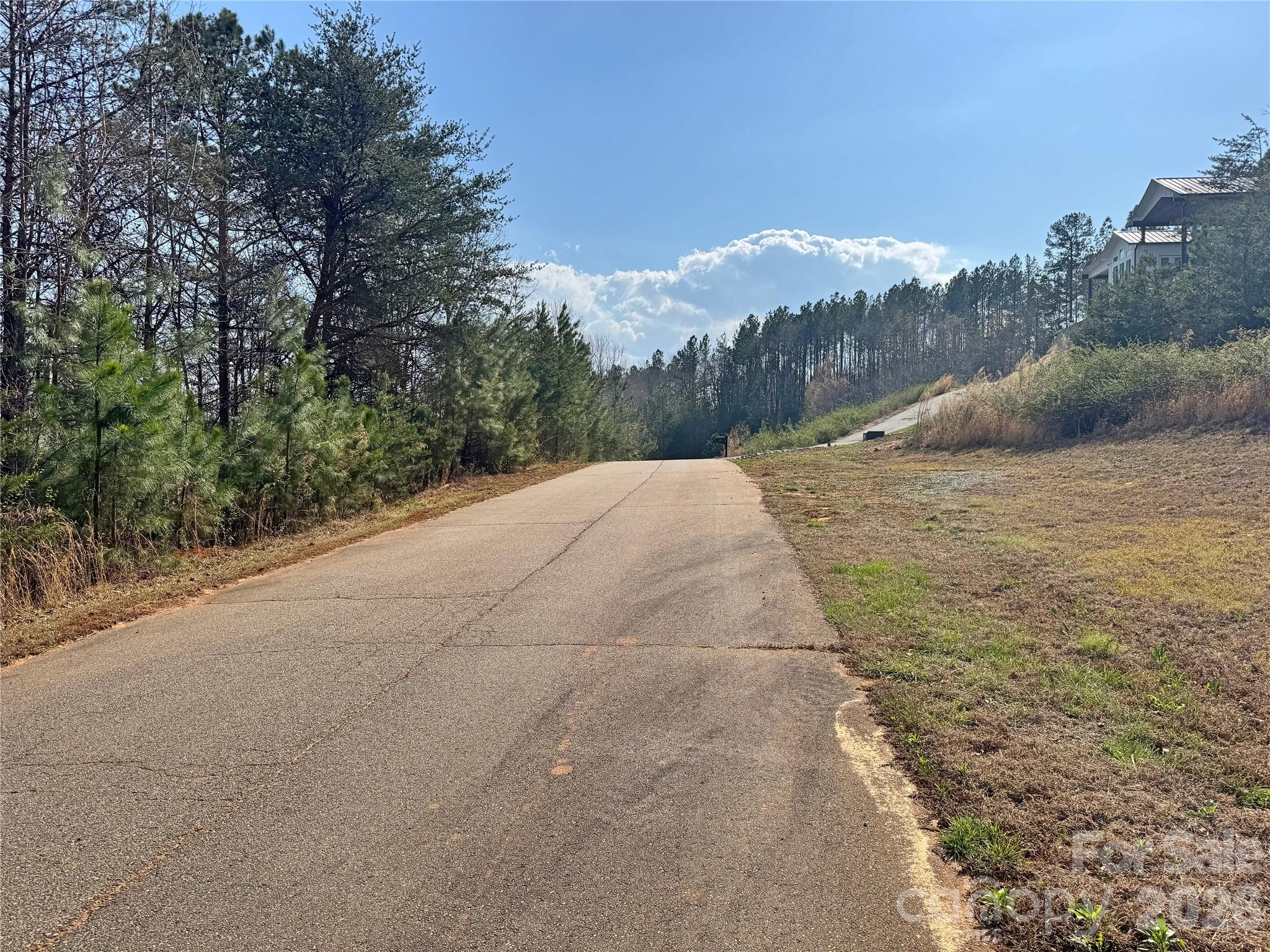 a view of a road with mountains in the background