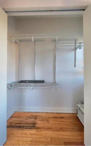 a view of a room with wooden floor