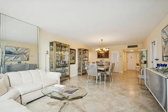 a living room with furniture and view of kitchen