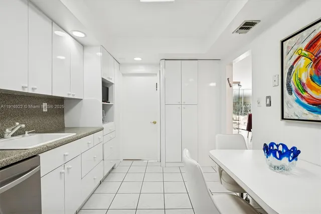 a kitchen with stainless steel appliances granite countertop a sink and a stove top oven
