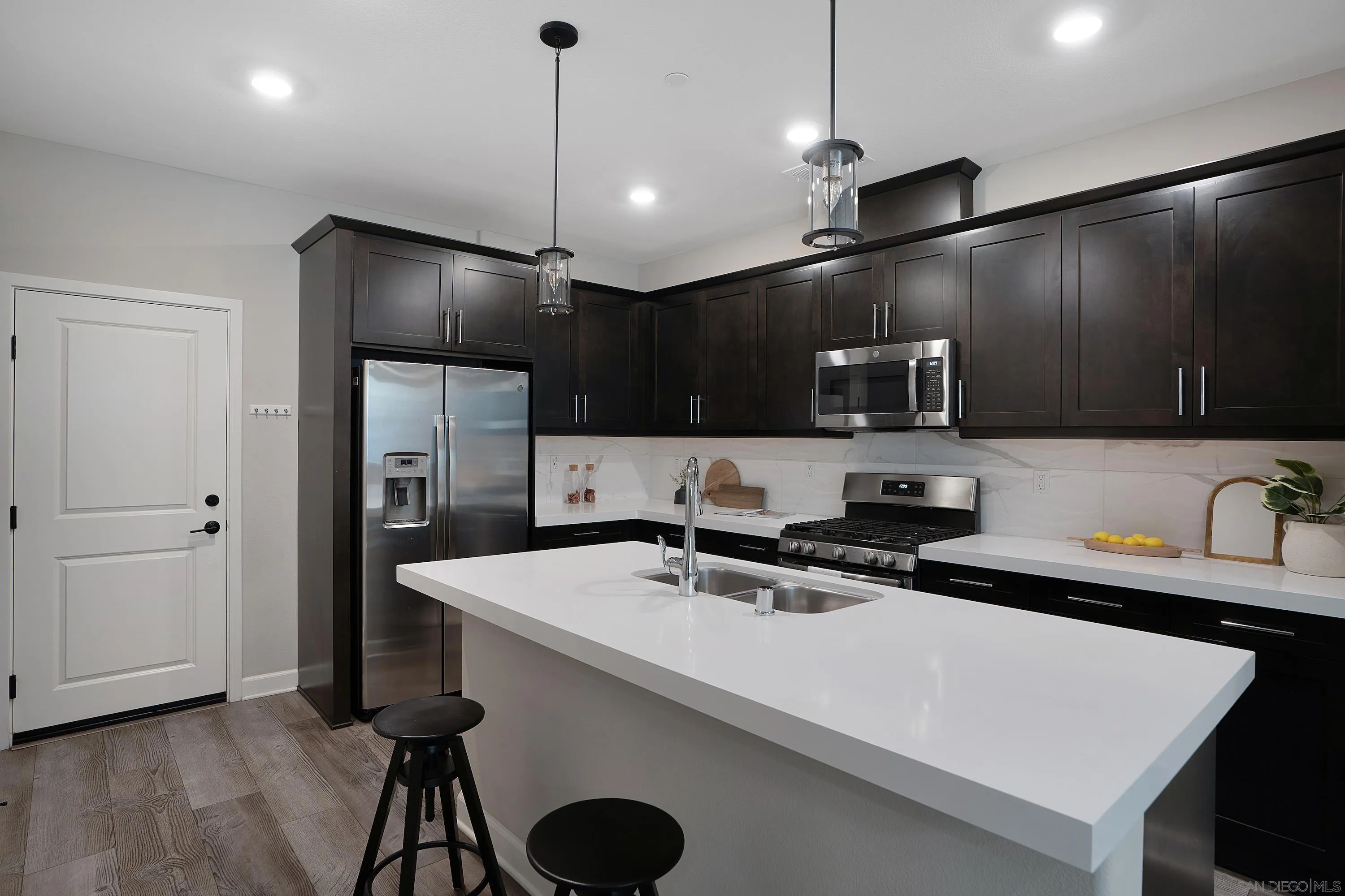 1172 Delpy View Point Vista, CA 92084 - Photo 9 of 29 a kitchen with stainless steel appliances a sink a refrigerator a sink and a stove