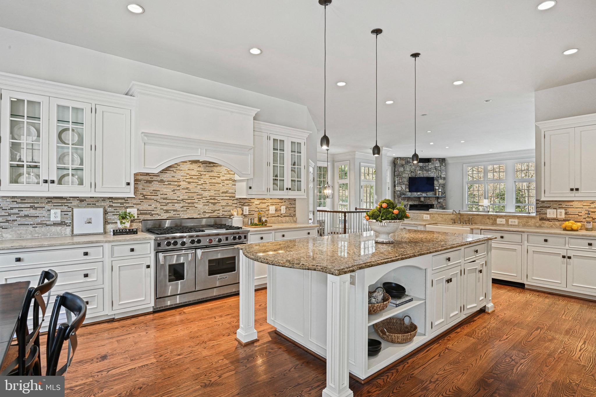 1064 Silent Ridge Court McLean, VA 22102 - Photo 16 of 70 a large kitchen with stainless steel appliances granite countertop a stove and a wooden floors