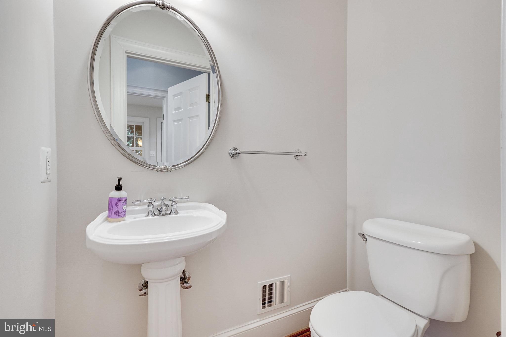 1064 Silent Ridge Court McLean, VA 22102 - Photo 23 of 70 a bathroom with a toilet sink and mirror