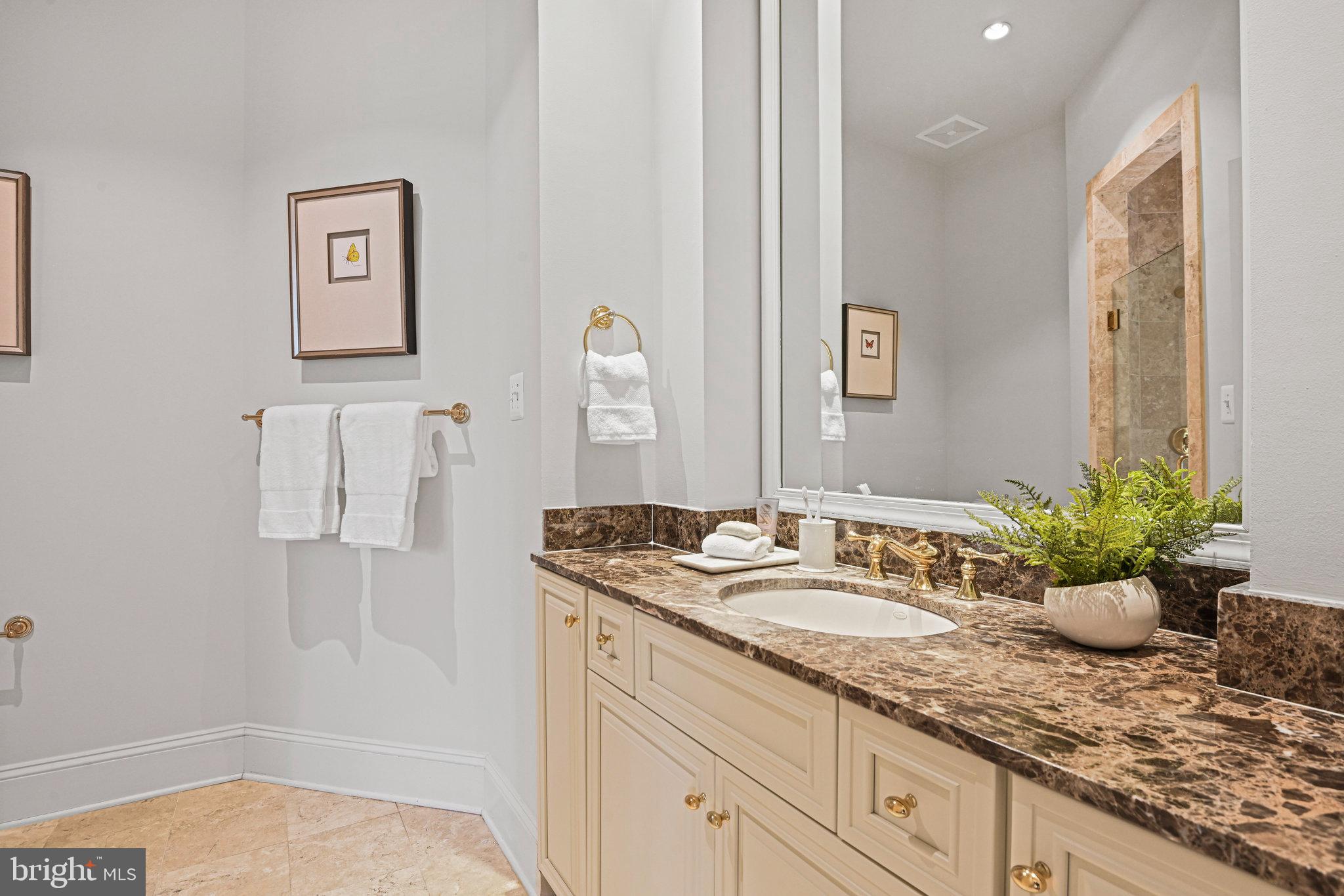 1064 Silent Ridge Court McLean, VA 22102 - Photo 31 of 70 a bathroom with a granite countertop sink and a mirror