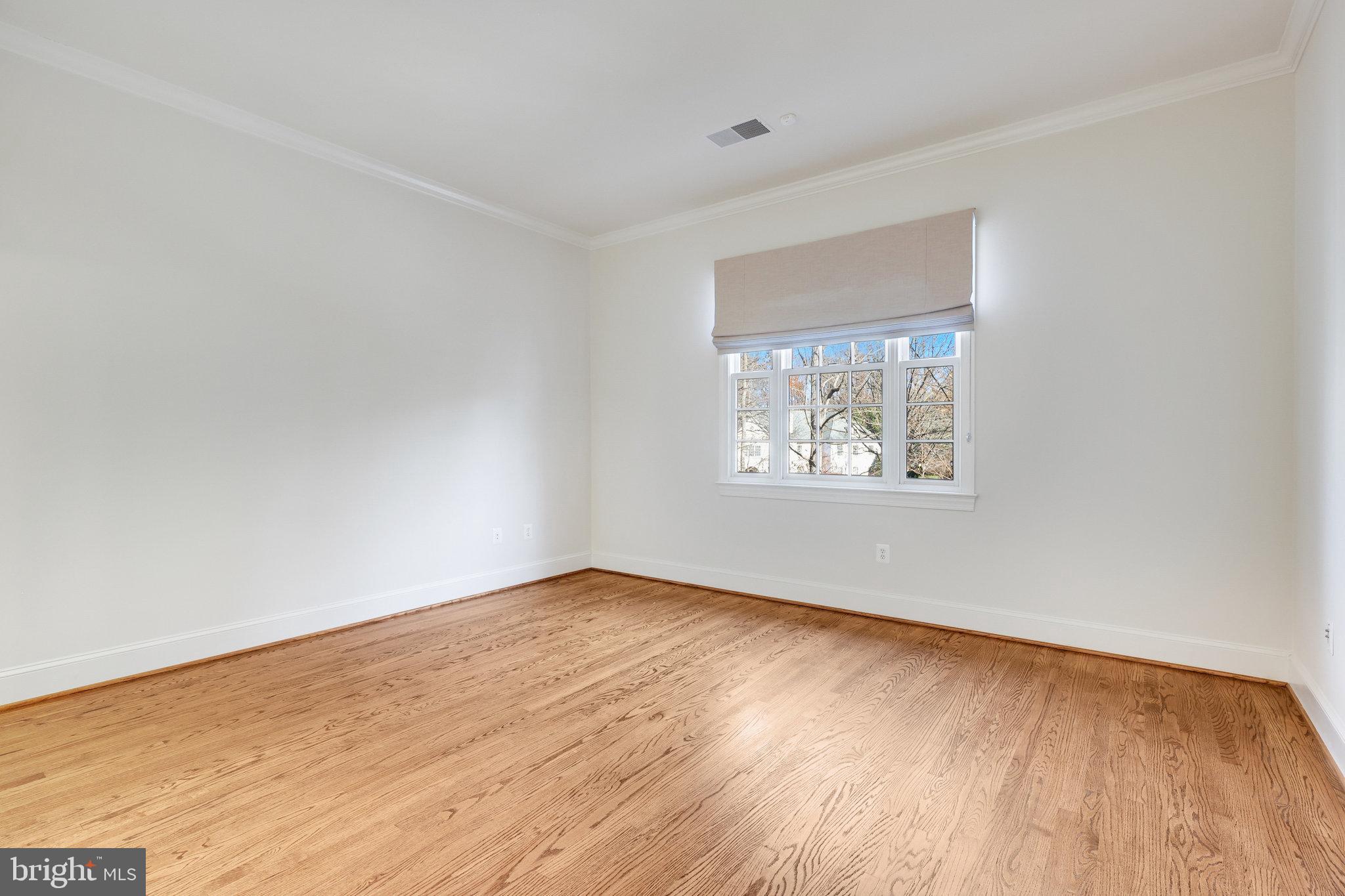 1064 Silent Ridge Court McLean, VA 22102 - Photo 39 of 70 an empty room with wooden floor and windows