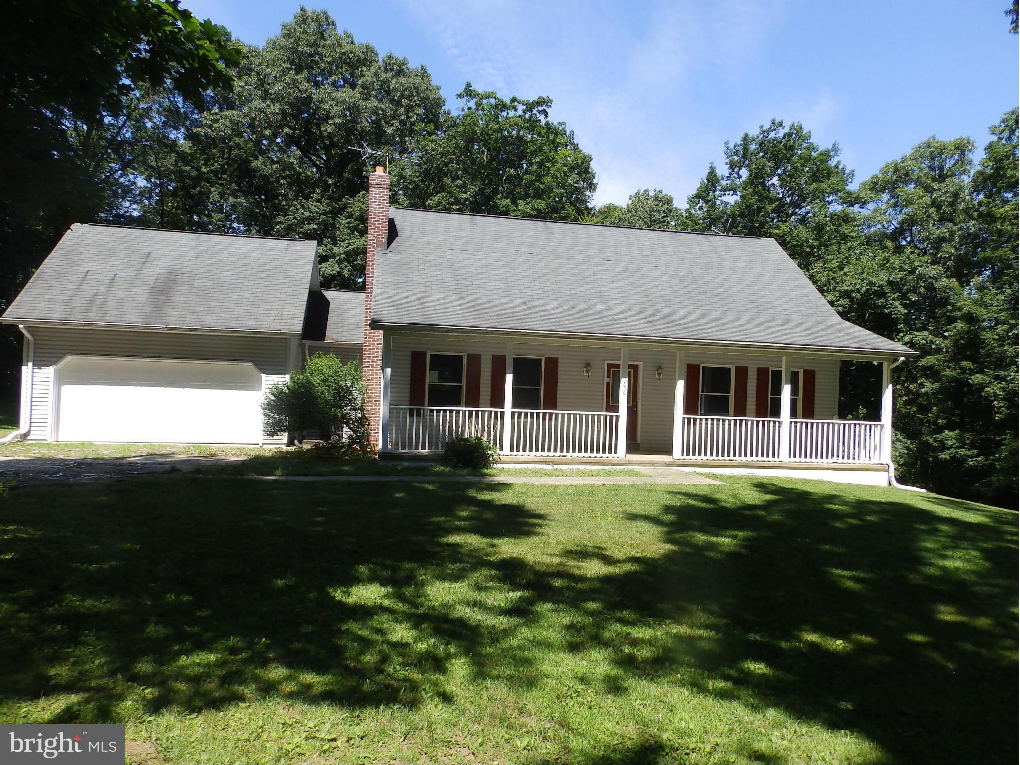 5250 Hoffmanville Road Manchester, MD 21102 - Photo 1 of 29 a front view of a house with a garden