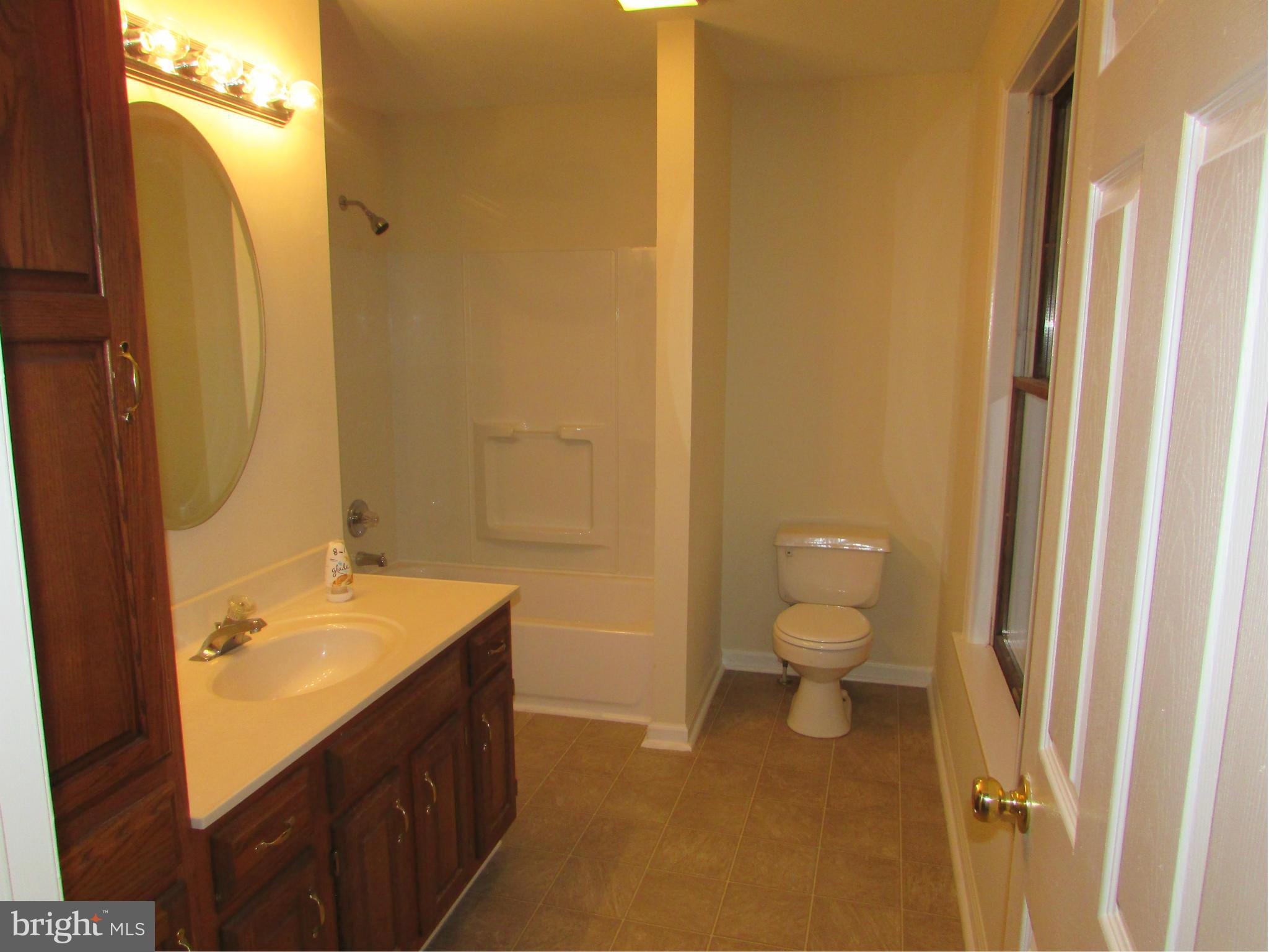 5250 Hoffmanville Road Manchester, MD 21102 - Photo 15 of 29 a bathroom with a granite countertop sink toilet and shower