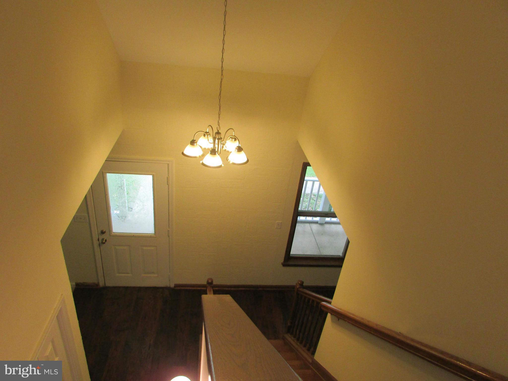 5250 Hoffmanville Road Manchester, MD 21102 - Photo 4 of 29 a view of a room with wooden floor and chandelier