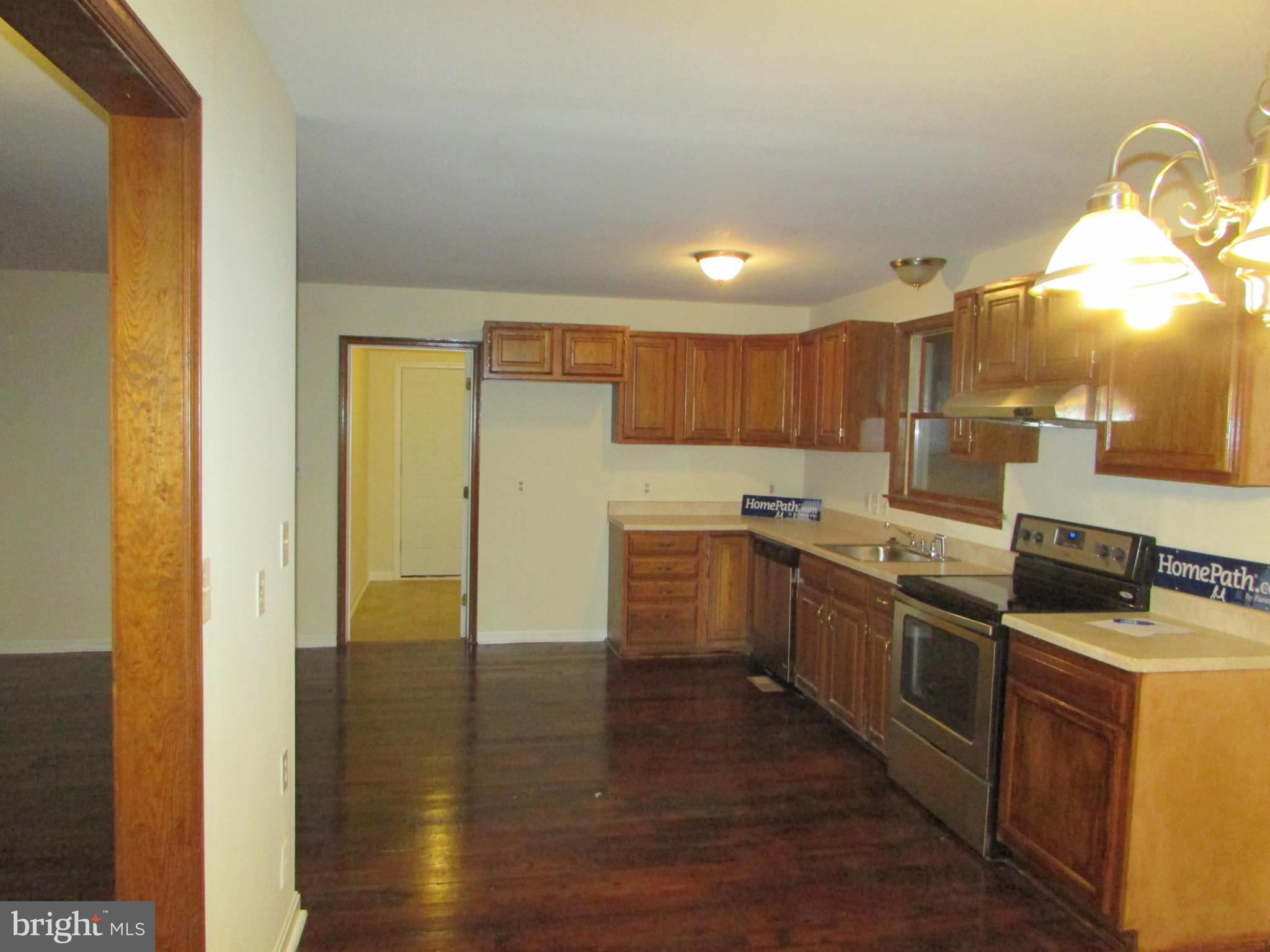 5250 Hoffmanville Road Manchester, MD 21102 - Photo 8 of 29 a kitchen with stainless steel appliances granite countertop a stove a sink and a refrigerator
