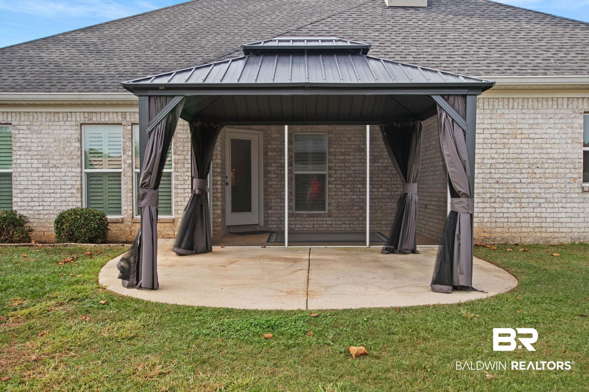 17376 Bankhead Boulevard Fairhope, AL 36532 - Photo 66 of 73 Rear view of house featuring a gazebo, a patio, brick siding, a shingled roof, and a yard