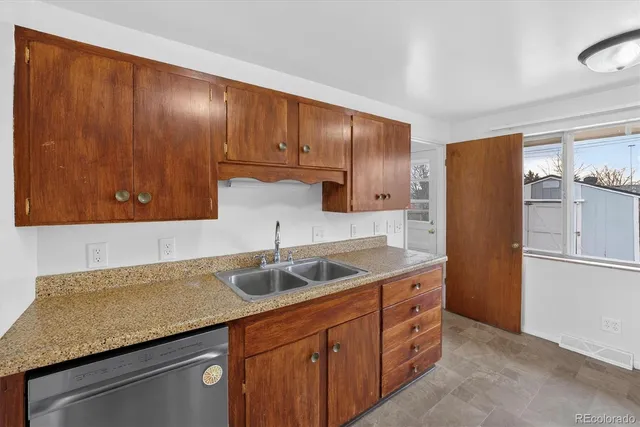 a kitchen with a sink cabinets and stainless steel appliances