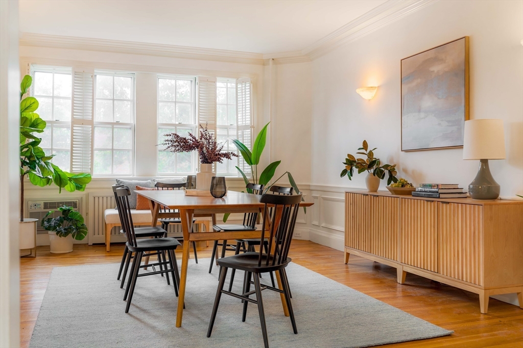 984 Memorial Drive, Unit 984503 Cambridge, MA 02138 - Photo 10 of 30 a view of a dining room with furniture window and wooden floor