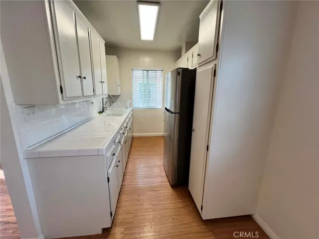 a bathroom with sink a mirror and a shower