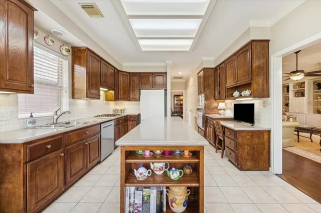 a kitchen with stainless steel appliances granite countertop a stove a sink and a microwave