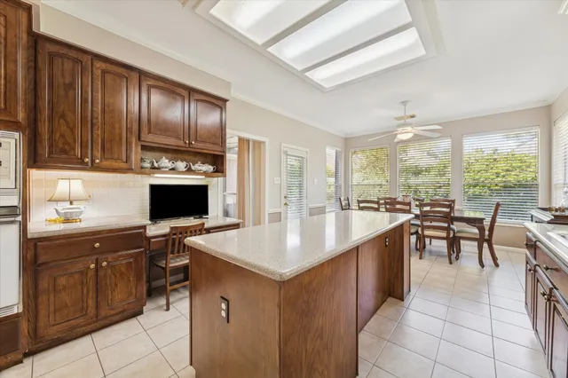 a kitchen with granite countertop a sink stove and cabinets