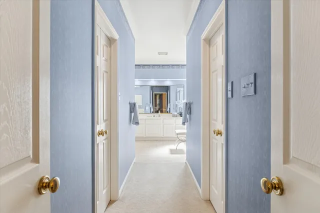 a view of a hallway with toilet and tub