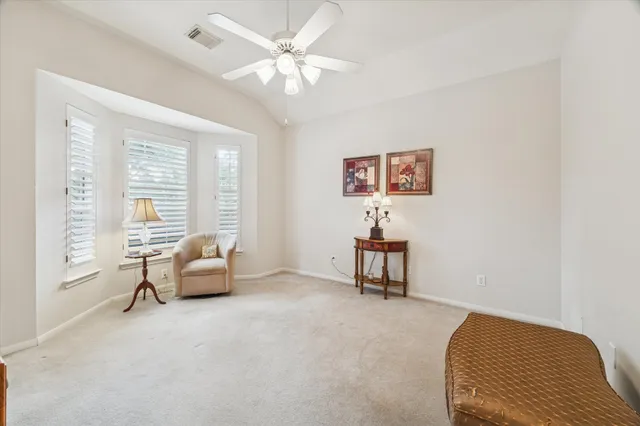 a bedroom with furniture and a large window