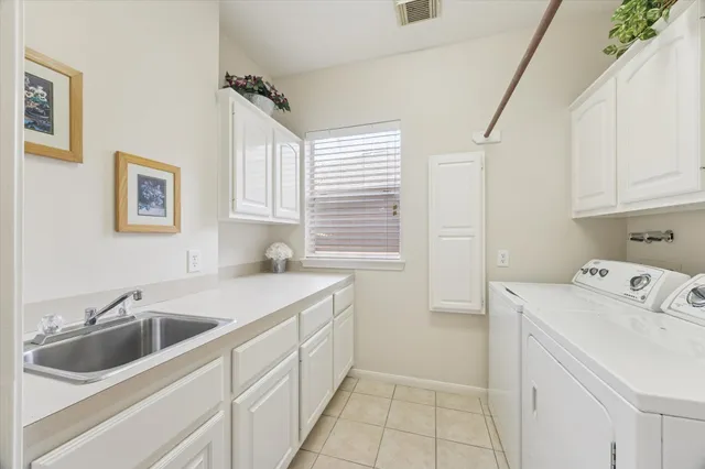 a utility room with a sink washer and dryer